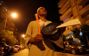 El Mesaharty, Hussien, 40, wakes up residents for their pre-dawn meals during the first day of Ramadan in Cairo, Egypt June 6, 2016. REUTERS/Amr Abdallah Dalsh